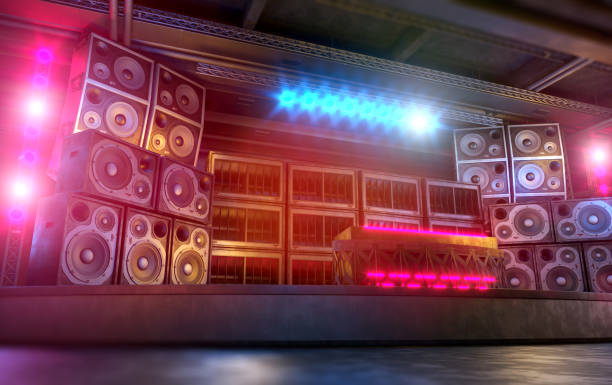 Sound stage with dj desk and large music system made of loudspeakers and subwoofers stacked on each other. Garage club location illuminated by blue and magenta lights. Rave party, punk and hard rock music background. Digitally generated image.